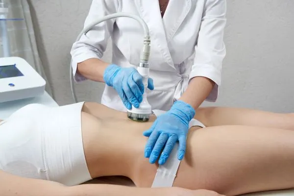 Lost the Weight but Not the Loose Skin? 2 woman having HIFU treatment on her stomach to combat loose skin Wraysbury following weight loss